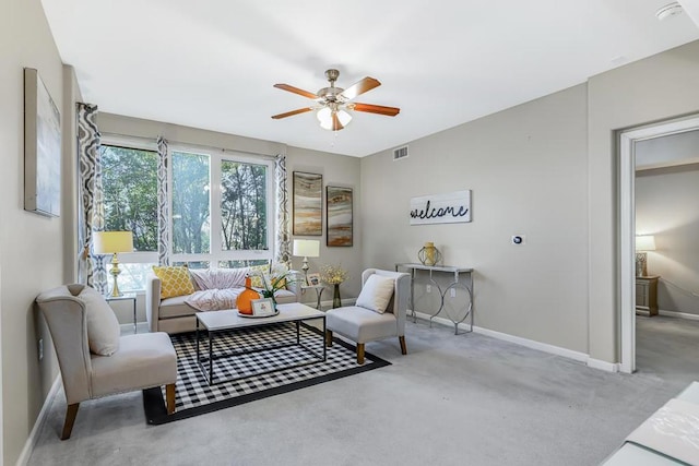 carpeted living room featuring ceiling fan