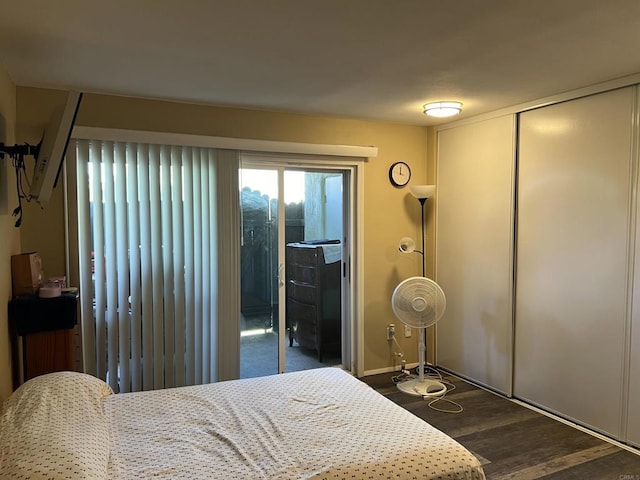 bedroom featuring dark hardwood / wood-style flooring and access to outside