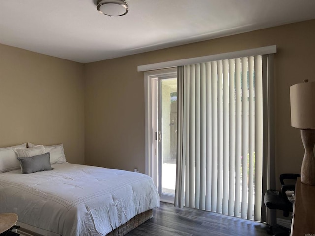 bedroom with dark hardwood / wood-style flooring and access to exterior