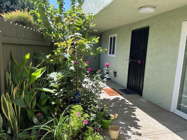 view of exterior entry featuring a patio area