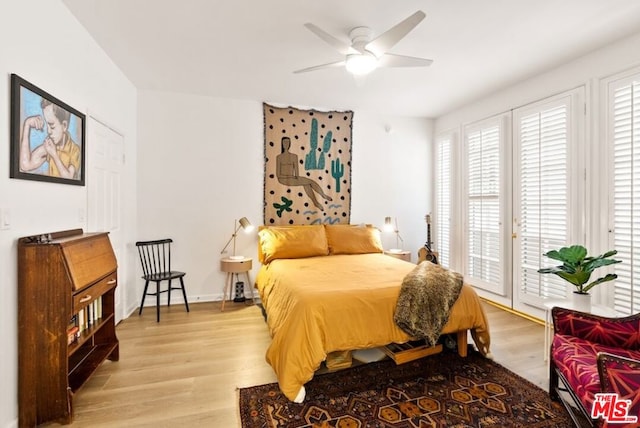 bedroom with multiple windows, ceiling fan, access to exterior, and light wood-type flooring