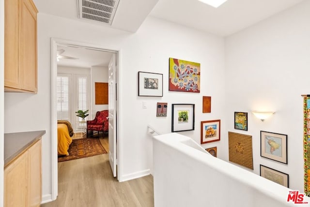 hallway with light hardwood / wood-style floors