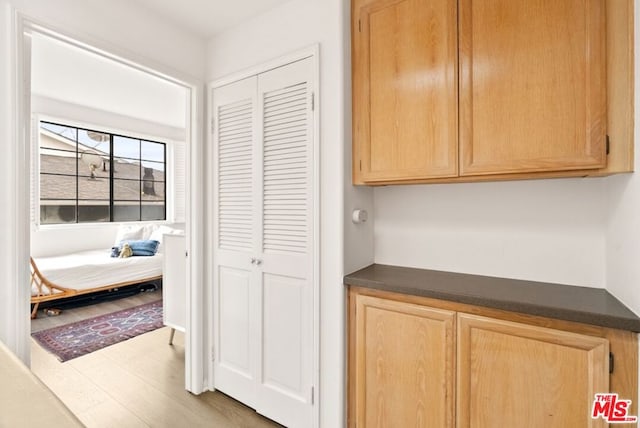 corridor with hardwood / wood-style flooring