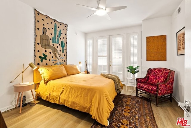 bedroom with wood-type flooring and ceiling fan