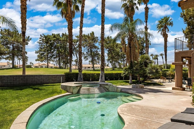 view of swimming pool featuring an in ground hot tub, a patio, and a lawn