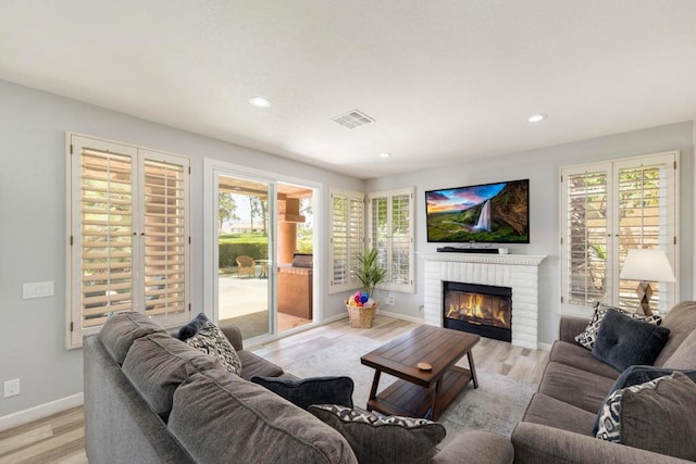 living room with a fireplace and light hardwood / wood-style floors