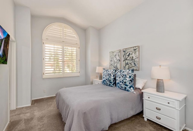 carpeted bedroom featuring lofted ceiling