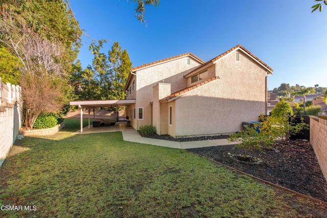 view of side of property with a lawn