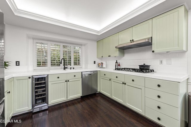 kitchen with appliances with stainless steel finishes, sink, backsplash, wine cooler, and dark hardwood / wood-style flooring