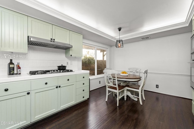 kitchen featuring pendant lighting, dark hardwood / wood-style floors, white gas stovetop, and crown molding