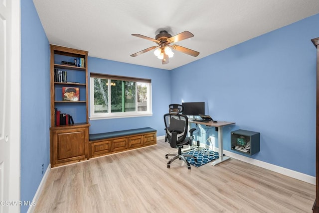 office featuring light hardwood / wood-style floors and ceiling fan