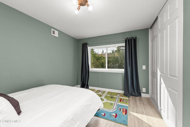 bedroom featuring light hardwood / wood-style floors and a closet