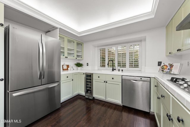 kitchen with appliances with stainless steel finishes, dark hardwood / wood-style floors, sink, wine cooler, and ornamental molding