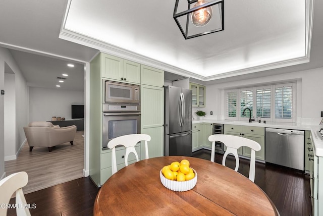 dining area with dark hardwood / wood-style floors, sink, beverage cooler, a tray ceiling, and crown molding