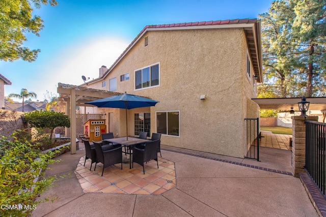 back of house featuring a patio and a pergola