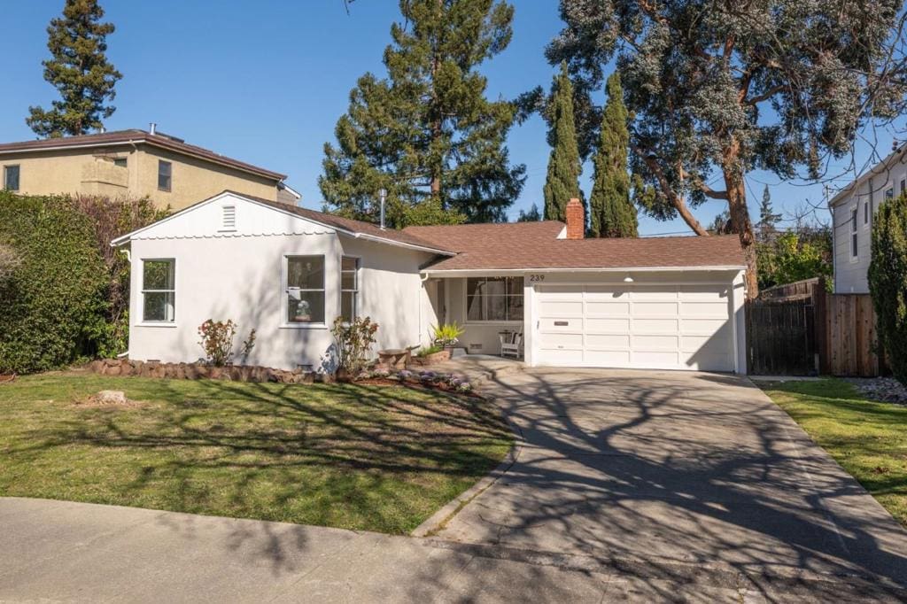 single story home with a garage and a front yard