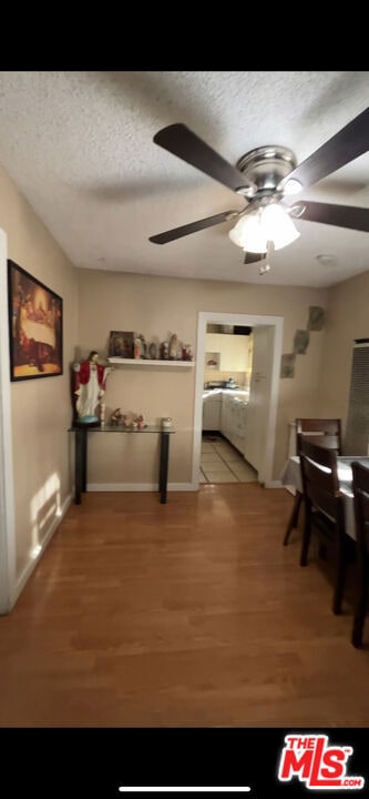 interior space featuring hardwood / wood-style flooring and a textured ceiling