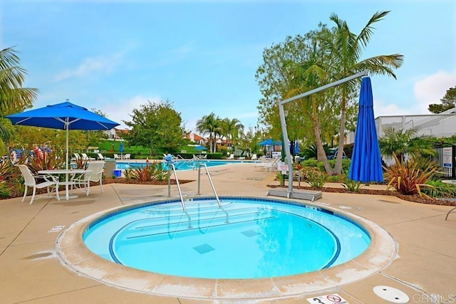 pool featuring a patio and a community hot tub