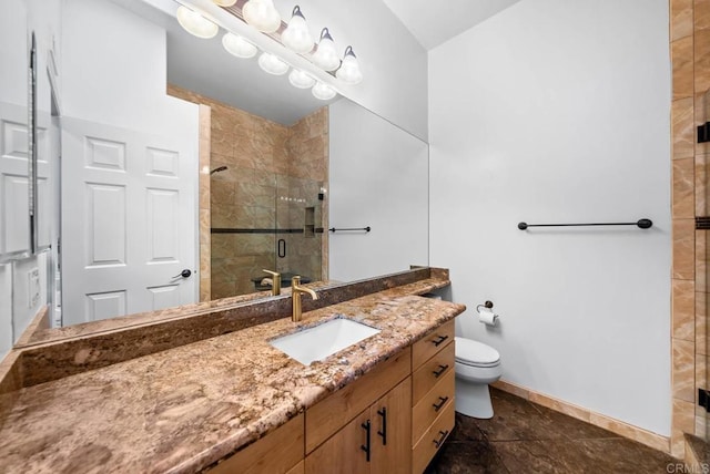 bathroom featuring a stall shower, baseboards, vanity, and toilet