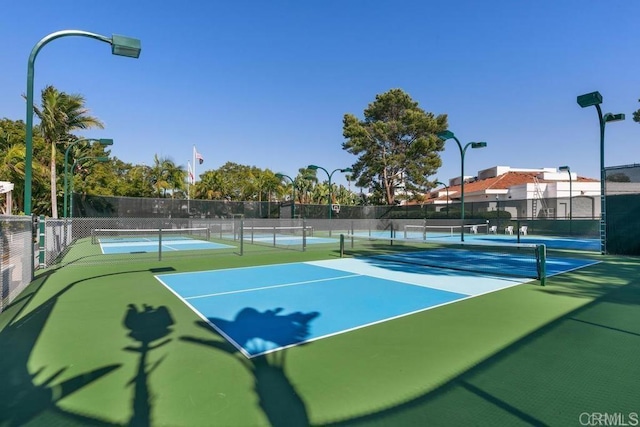 view of tennis court featuring fence