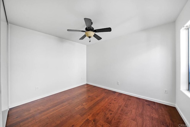 empty room featuring ceiling fan, wood finished floors, and baseboards