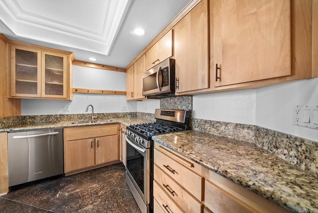 kitchen with light brown cabinets, recessed lighting, a sink, appliances with stainless steel finishes, and a raised ceiling