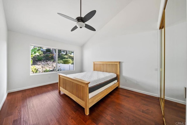 bedroom featuring a ceiling fan, lofted ceiling, baseboards, and wood finished floors