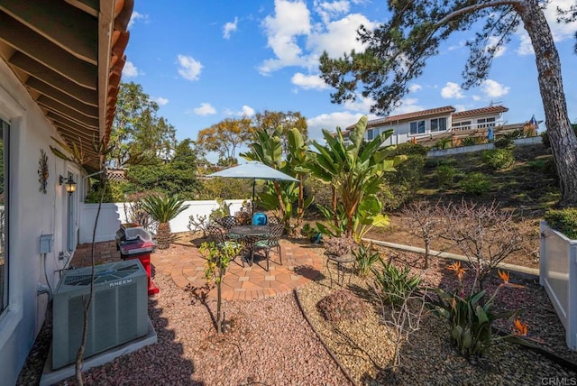 view of yard featuring a patio, central AC unit, and a fenced backyard