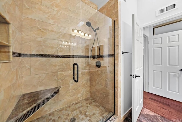 bathroom featuring a shower stall and visible vents