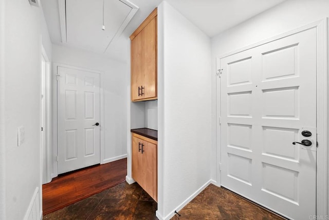 interior space featuring stone finish flooring and baseboards