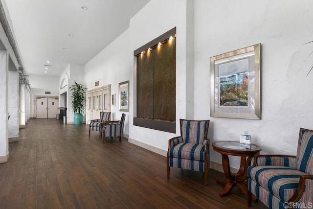 corridor with baseboards and wood finished floors