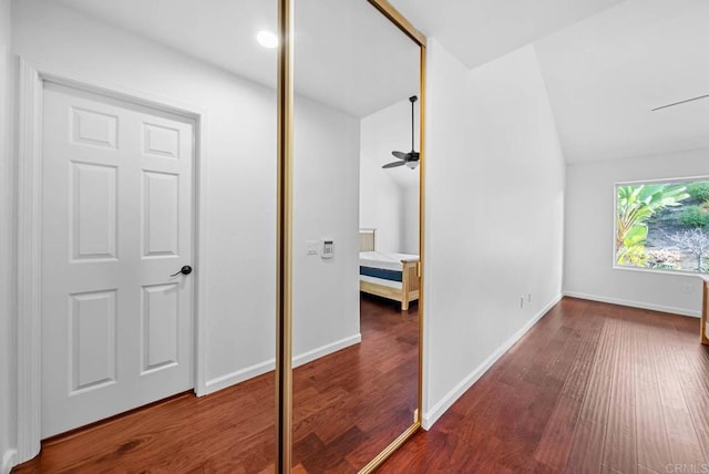 bedroom featuring vaulted ceiling, wood finished floors, and baseboards