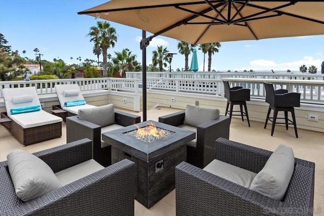 view of patio / terrace featuring an outdoor living space with a fire pit