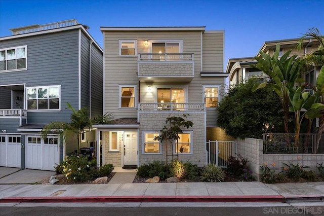 view of front of home featuring a balcony and a garage