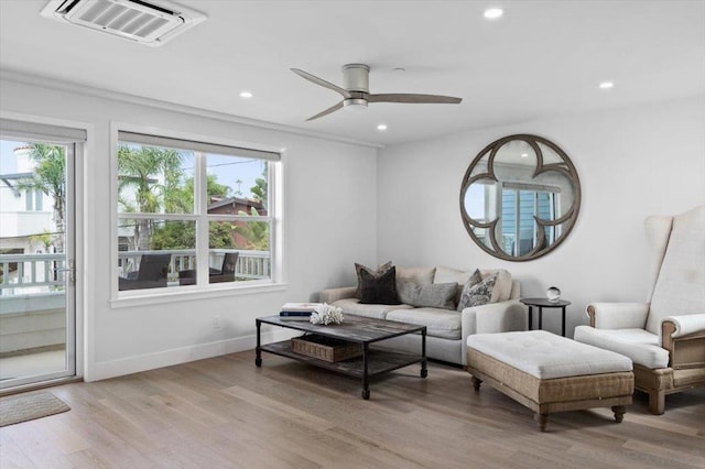 living room featuring ceiling fan and light hardwood / wood-style flooring