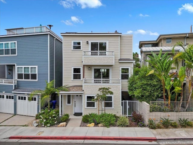 townhome / multi-family property featuring a balcony and a garage