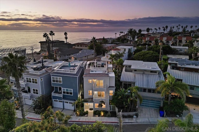 aerial view at dusk with a water view