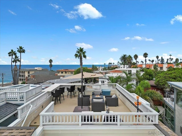 exterior space featuring outdoor lounge area and a water view