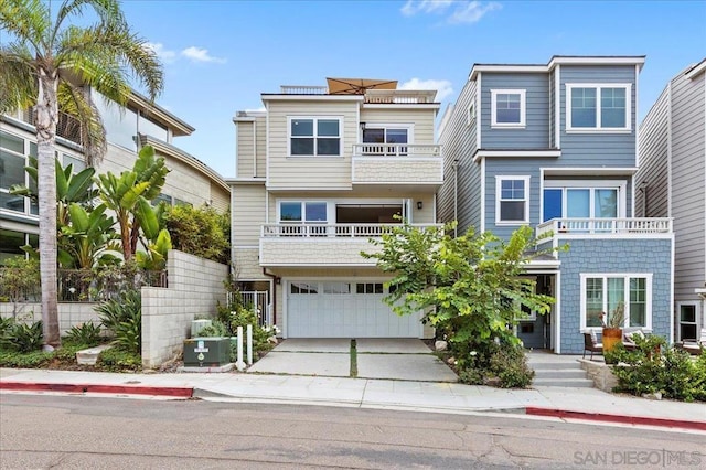 view of property with a garage and a balcony