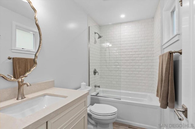 full bathroom with vanity, combined bath / shower with glass door, and toilet