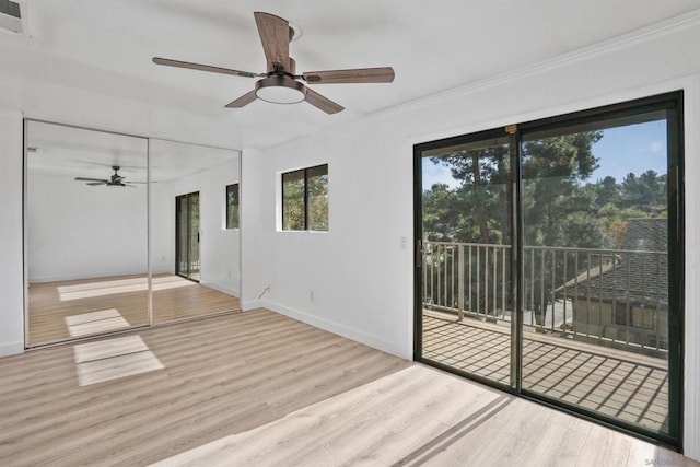 interior space with ceiling fan, ornamental molding, and hardwood / wood-style floors