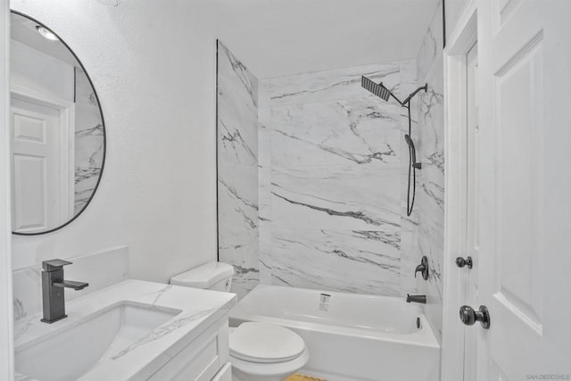 full bathroom with tiled shower / bath, vanity, and toilet