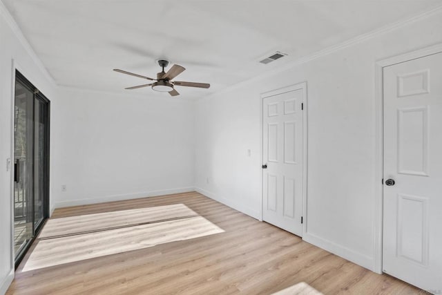 empty room with ornamental molding, ceiling fan, and light wood-type flooring