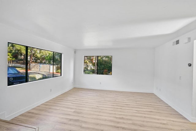 unfurnished room with light wood-type flooring