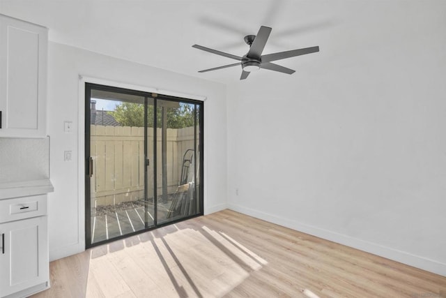 empty room featuring ceiling fan and light hardwood / wood-style flooring