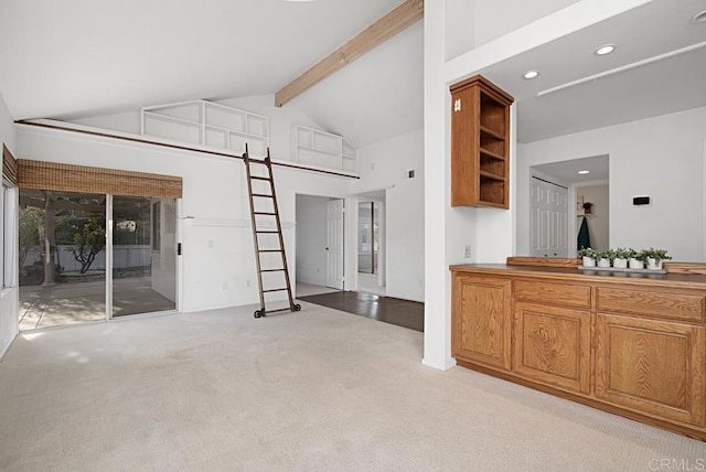 living room featuring light colored carpet, a barn door, high vaulted ceiling, and beam ceiling