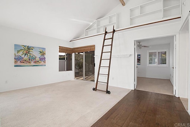 empty room with hardwood / wood-style floors and high vaulted ceiling