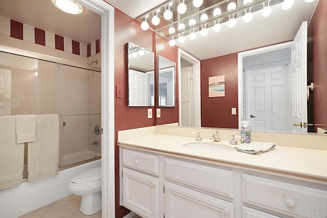 full bathroom featuring vanity, tile patterned floors, shower / bath combination with glass door, and toilet