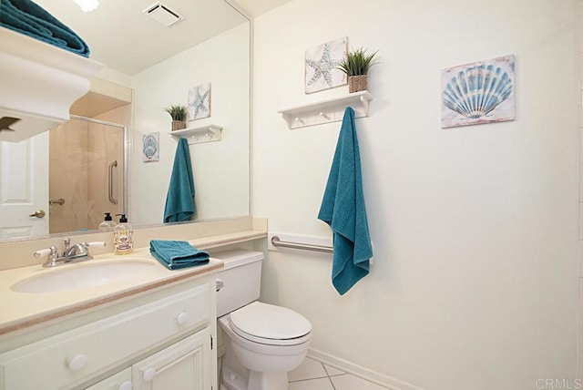 bathroom featuring an enclosed shower, vanity, tile patterned floors, and toilet