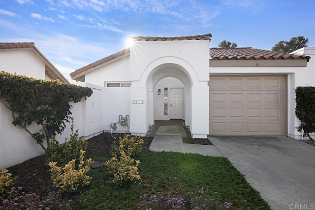 mediterranean / spanish-style home with a garage